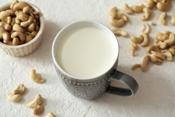 Alternative vegan cashew milk in a cup on a table