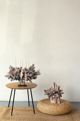 Gentle and beautiful Christmas arrangement of handmade flowers and candles in the interior. Christmas mood.