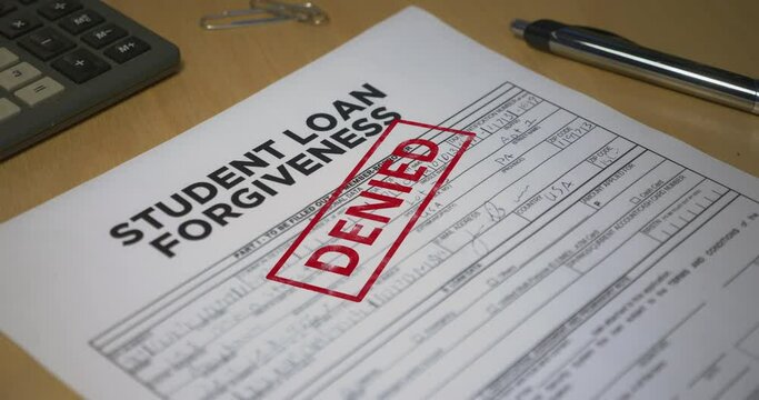 A closeup view of a student loan application getting denied. Data on form is fictional.	