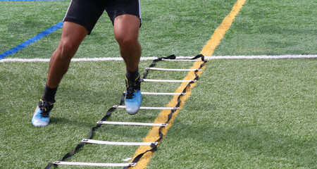 Legs of an athlete running side to side in a football ladder drill - obrazy, fototapety, plakaty