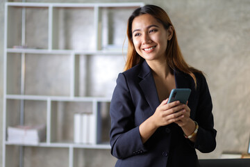 Portrait of charming businesswoman in office happy and drinking hot coffee.