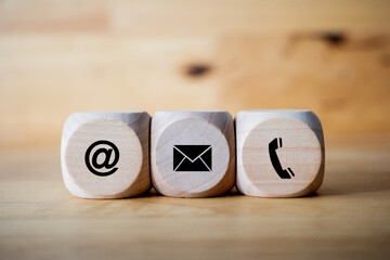 contact us icon (phone, email, mail ) on wood cube, customer service and support call center concept