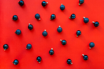 Glossy, matte and glitter dark blue Christmas tree balls on a red background. Christmas ornaments. Preparing for the New Year. Beautiful Christmas decorations. 