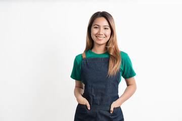 Cheerful young pretty asian woman green t-shirt and apron coffee owner isolated on white background. looking camera.