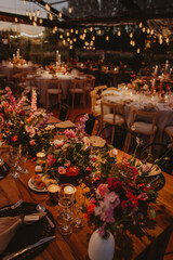 Wooden table with flowers and candles, wedding decoration.