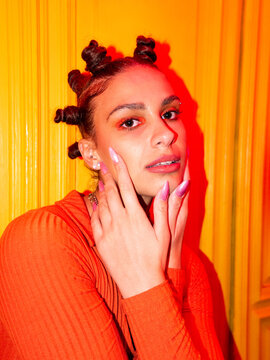 Trendy woman with bantu knots in studio