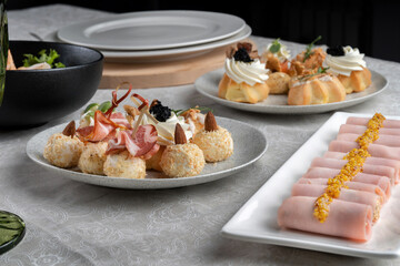 Stuffed ham rolls garnished with Dijon mustard. Plate on the festive table.