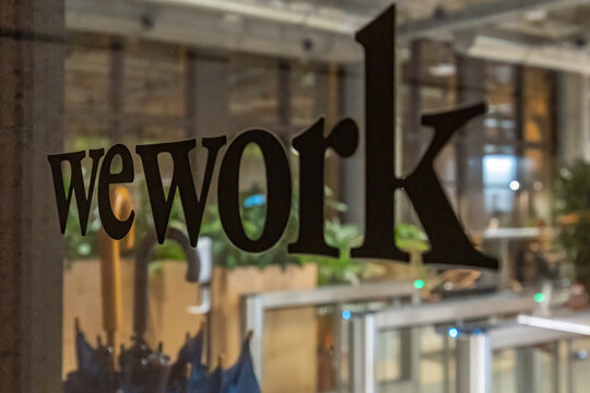 wework lettering on the glass door at night