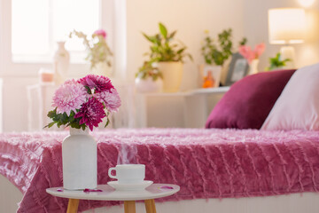 hot drink in white cup on background pink and white bedroom