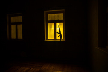 Conceptual photo of war between Russia and Ukraine. Ukraine and Russia flags on windowsill at...