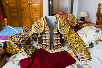 Traditional torero jackets on bed