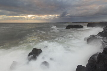 Sea wave on long exposure during sunset on the seashore