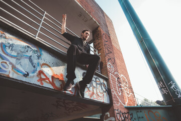 Man jumping outdoors doing parkour exercise training doing tricks