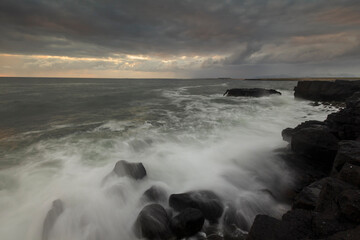 Sea wave on long exposure during sunset on the seashore