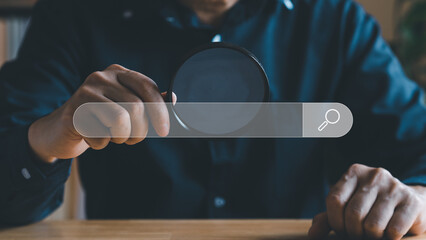 Internet online searching concept. Hand hold magnifying glass search job or information in web...