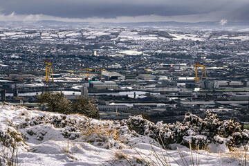 Samson and Goliath twin shipbuilding cranes at Queen's Island, Belfast, Northern Ireland. View form Cave Hill mountain in the snow.