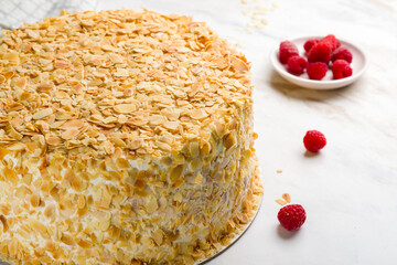 The Esterhazy cake with almonds on white marble table