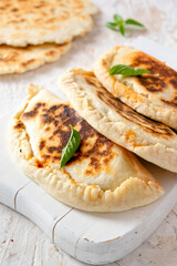 Traditional Italian calzone with ham, mozzarella cheese and tomato sauce, made with piada dough.