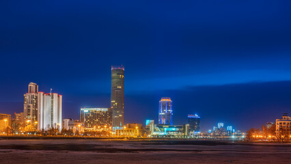 Early Spring night on the banks of the pond in the city center