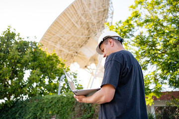 Engineer looking earth based astronomical radio telescope