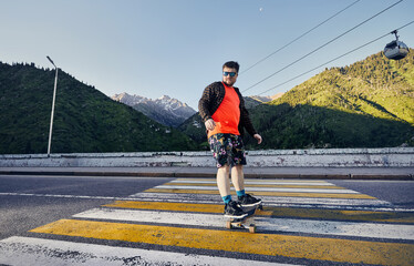 Skater traveling in the mountains on his longboard