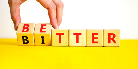 Better or bitter symbol. Concept word Better and Bitter on wooden cubes. Businessman hand....