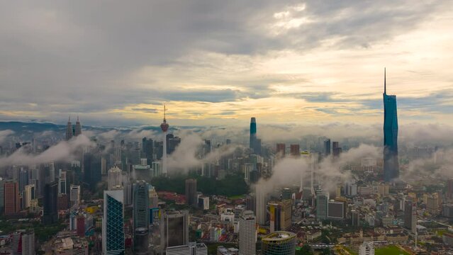 Monsoon Time lapse Aerial view of Kuala Lumpur cityscape during low cloud sunrise with the city as the background on monsoon season