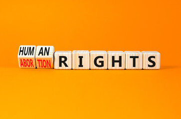 Abortion rights symbol. Concept words Abortion rights are human rights on wooden cubes. Beautiful orange table orange background. Business medical abortion rights concept. Copy space.