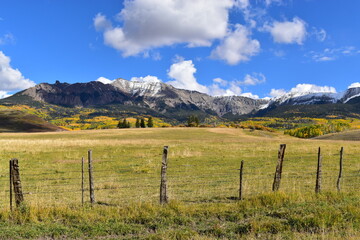 Old wooden cattle fence with mountain background