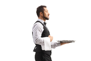 Profile shot of a waiter carrying a silver tray