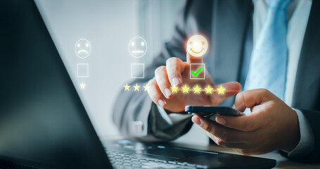 Fototapeta na wymiar Customer service and Satisfaction concept. Business people are touching the virtual screen on the happy Smiley face icon to give satisfaction in service. rating very impressed. evaluation. Customer.