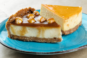 Nut vanilla cheesecake with salty homemade caramel on a blue plate.