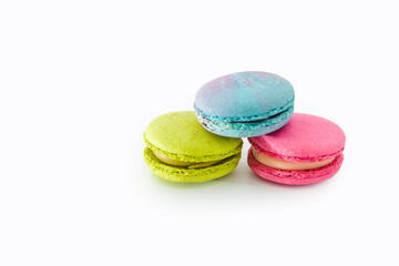 Fototapeta na wymiar Brightly colored stacked macarons isolated on white background. Tasty colorful macaroon assorted. Three sweet macaroons cakes. French pastry made from egg whites. Culinary and cooking concept.