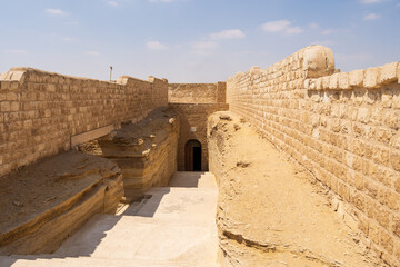 The entrance to the Serapeum, the ancient Egyptian burial place for sacred bulls (Apis) with the large sarcophagi for the mummified bulls in Saqqara, Egypt.  Travel and history.