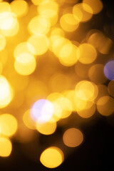 Obraz premium Abstract background of blurred yellow lights for design. Lights bokeh dis focus. Christmas background, copy space