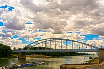 Naklejka premium Tisza river bridge and clouds in Szeged