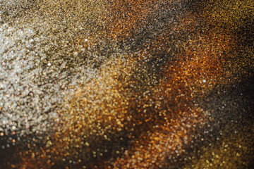 Abstract background of blurred yellow glitter for design. Lights bokeh dis focus. Christmas background, copy space