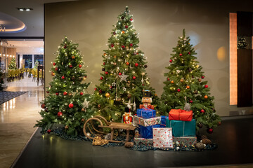 a colorfully decorated Christmas tree stands as decoration in the foyer