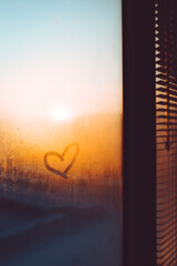 Heart drawn on a misty window