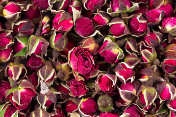 Heap of dry tea roses buds background. Rose flower tea. Phnom Penh rose tea. Clipping path. Top...