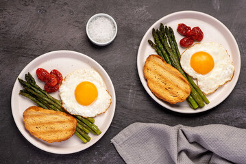 Food photography of fried egg, tomato, asparagus, toast,  salt, breakfast