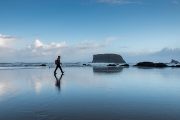 morning walk on Bandon beach with the Table Rock in the background, Oregon, USA