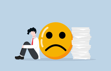Stress and depression from overwork or too many responsibilities, toxic work environment, job burnout concept, Businessman feeling depressed sitting near negative emoji and stack of documents.