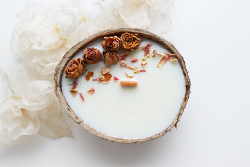 original candle in coconut from natural soy wax with a wooden wick	 - obrazy, fototapety, plakaty