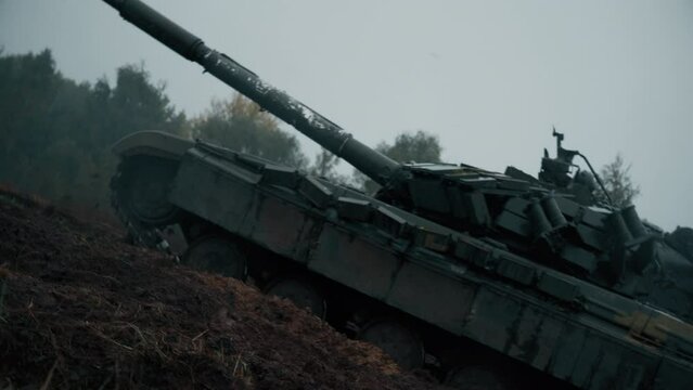 Dynamic handheld camera shoot Ukraine Tank T-72 on the battlefield.