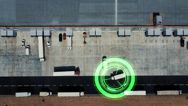 Driverless delivery van scans the road and moves without a driver. Delivery cargo truck moves through the logistics center to load goods. Concept of smart transportation and trucking. 