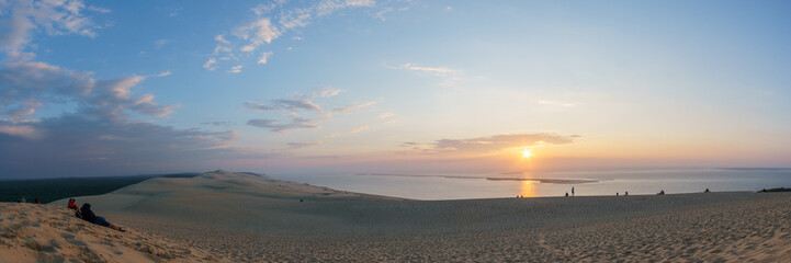 Panorama of sunset with view at the sea on a huge natural sand formation on the Dune du Pilat, Arcachon, Nouvelle-Aquitaine, France