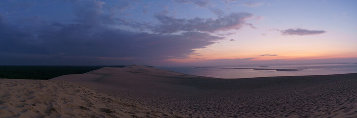 Panorama of twilight after sunset with view at the sea on a huge natural sand formation on the Dune...