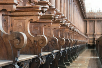 Cathedral choir stalls made of wood in Salamanca, Spain. Row of wooden choir stalls