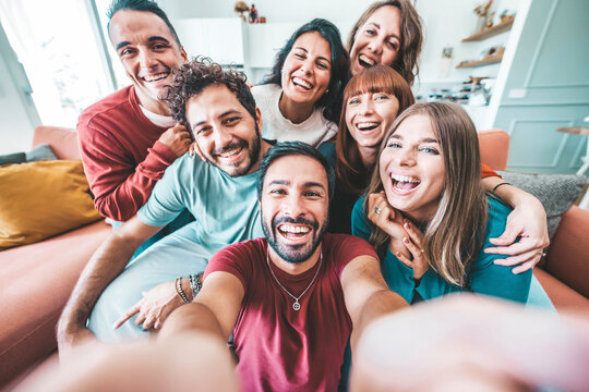 Group of friends taking selfie with smart mobile phone device at home - Happy young people smiling together at camera - University students having fun together in college campus - Friendship concept